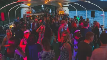 People dancing on a boat at night.