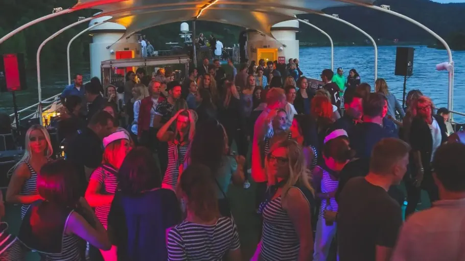 People dancing on a boat at night.