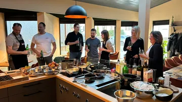 Group socializing in a modern kitchen.
