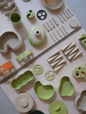 Colorful ceramic shapes arranged on a table.
