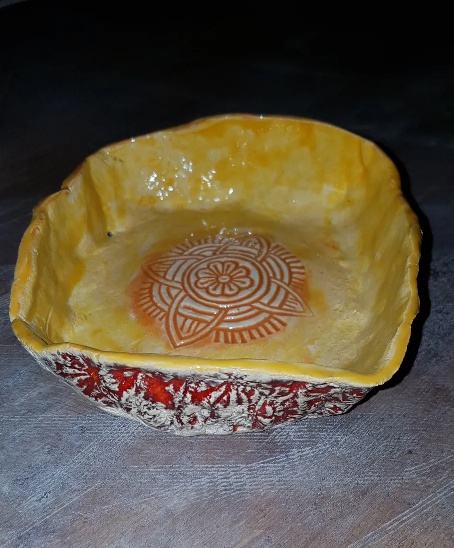 Handmade ceramic bowl with intricate pattern inside.