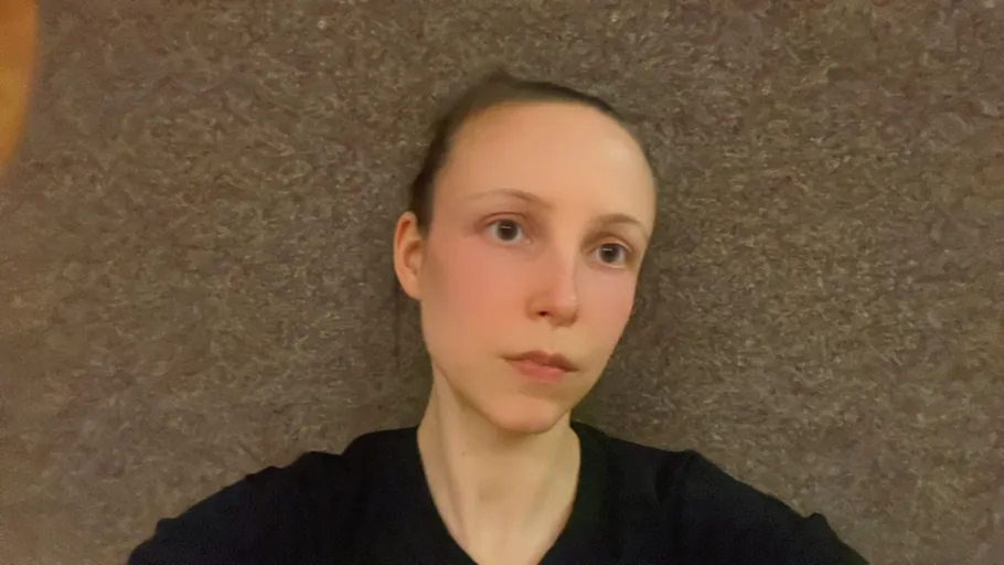 Person lying on a carpeted floor indoors.