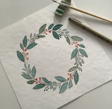 Leaf and berry wreath on white paper.