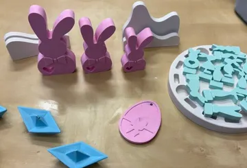 Colorful 3D-printed Easter decorations on table.