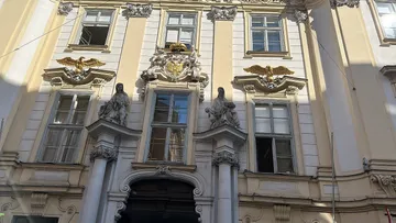 Baroque facade with statues and windows.