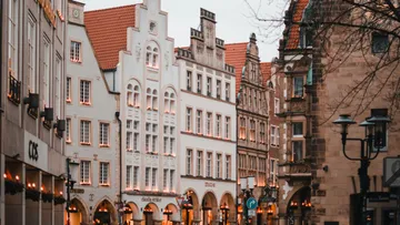 Historic gabled buildings on a city street.