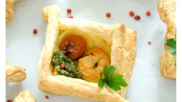 Pastry filled with pesto, shrimp, and tomato.