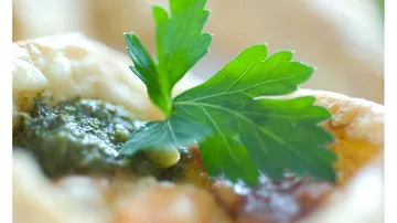 Pastry with parsley and pesto on top.