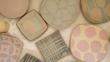 Decorative plates with geometric patterns on display.