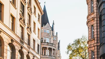 Ornate historic buildings under clear sky.