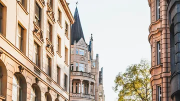 Historic buildings with ornate architecture under clear sky.