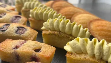 Pastries with toppings on display table.