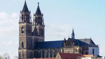 Gothic cathedral with two towers, clear sky.