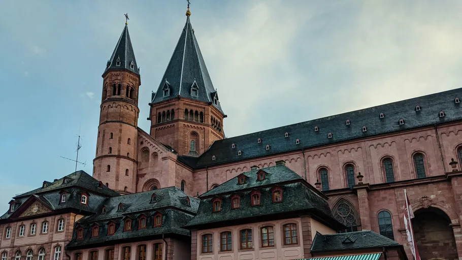 Old cathedral towers against cloudy sky.