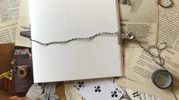 Open scrapbook with cards and pages around.