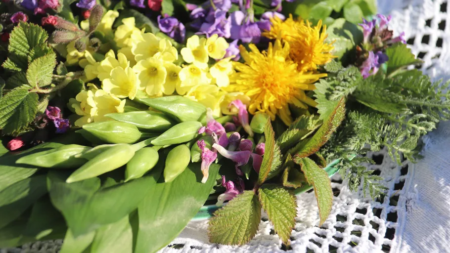 Colorful spring flowers on a lace tablecloth.