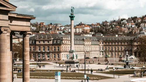 Column and historic buildings in city square.