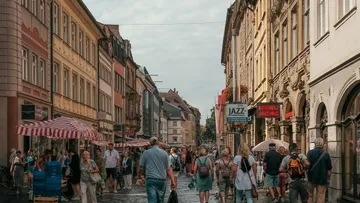 People walking on a busy street with shops.