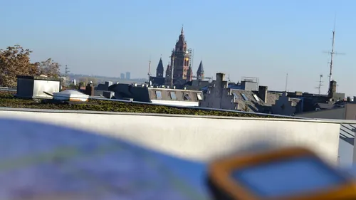 Cathedral in distance viewed over rooftops.