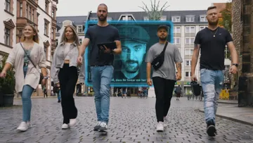Five people walking in urban setting.