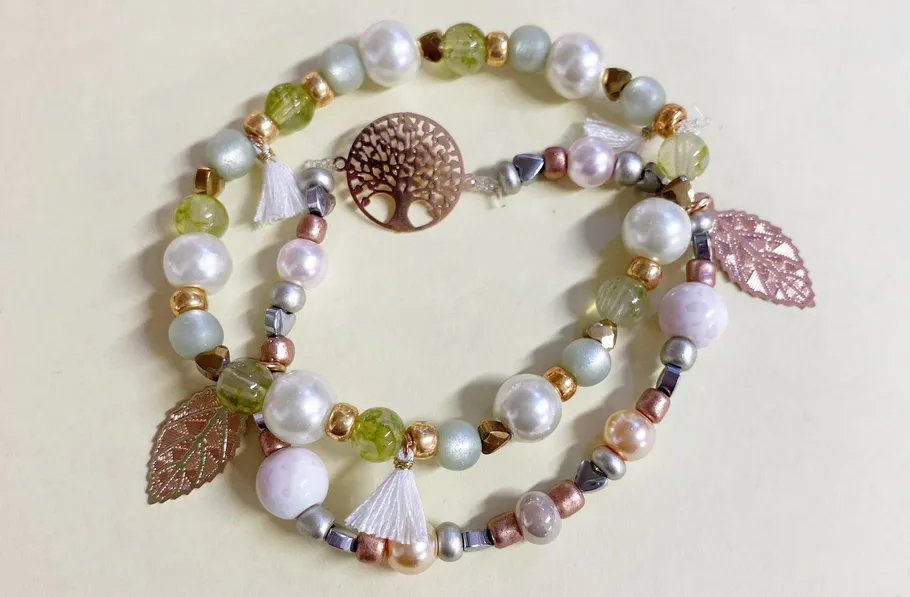 Decorative bracelets with pearls and metal charms.