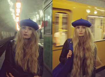 Woman in blue beret at subway station.