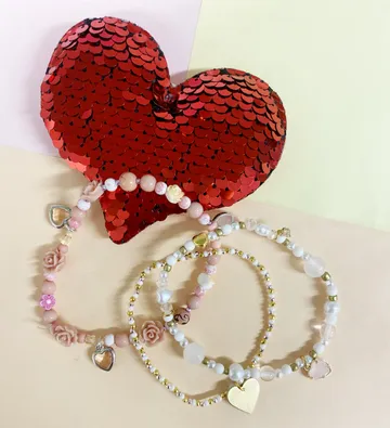 Heart-shaped sequins with beaded bracelets displayed.