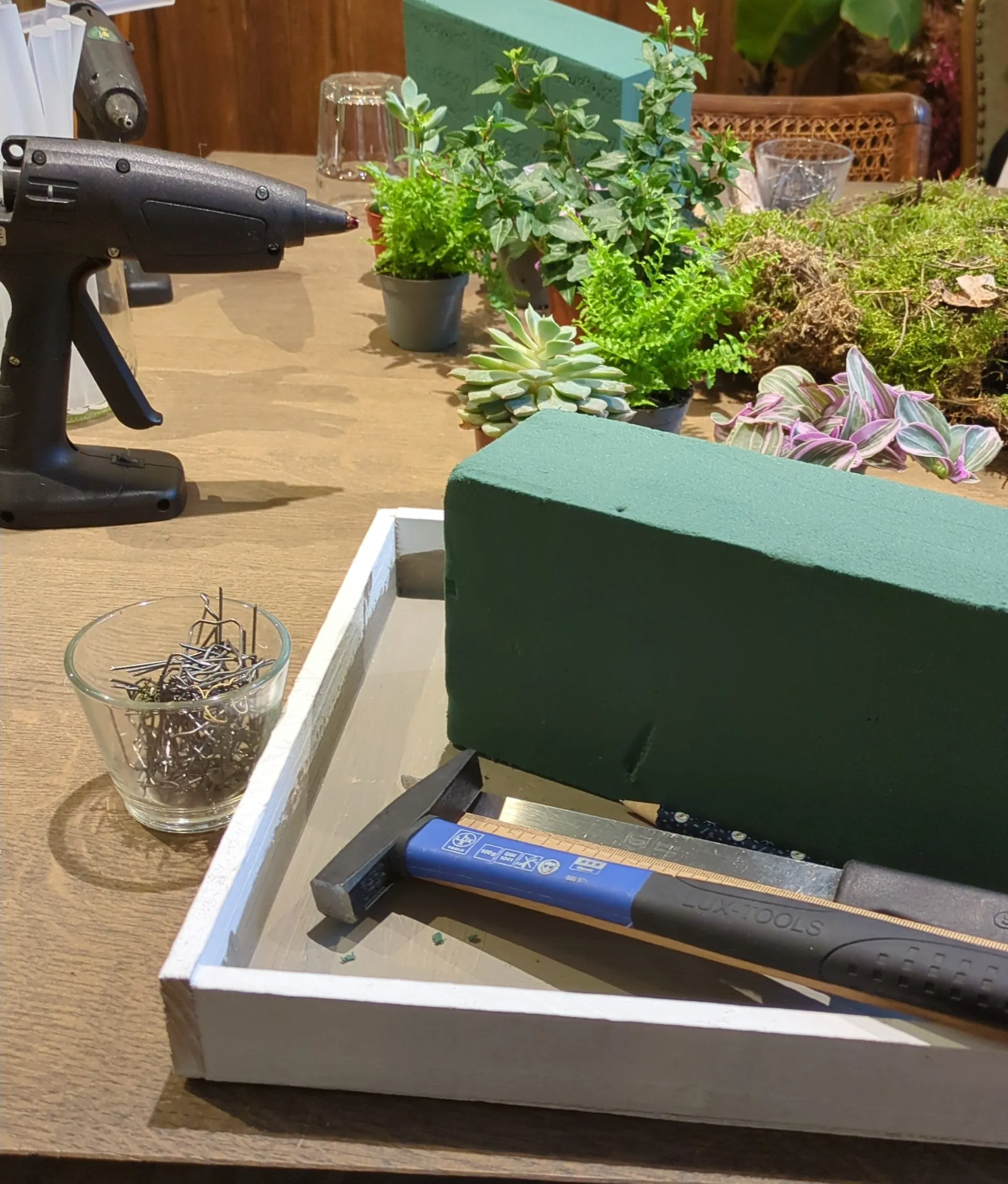 Floral supplies on table with tools.