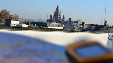Cathedral view over city rooftops in daytime.