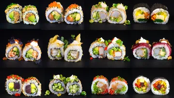 Verschiedene Sushi-Rollen auf schwarzem Hintergrund.