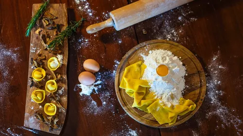 Pasta ingredients on wooden table surface.