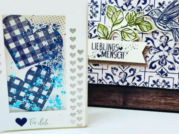 Colourful hearts in a frame surrounded by floral motifs.