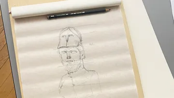 Sketchpad with pencil sketch of soldier.
