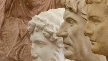 Three ancient busts in profile view.