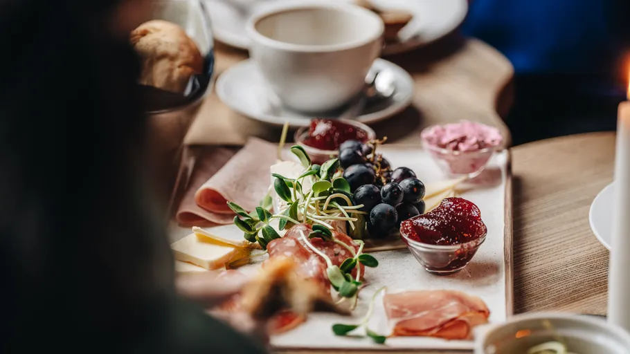 Charcuterie board with fruits and spreads on table.