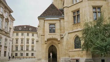 Historic building with archway and windows.
