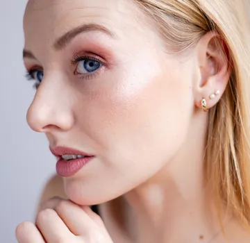 Close-up of woman's face with earrings.