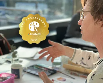 Person explaining art materials on table.