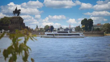 Boat sailing on river by historic monument.