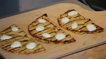 Grilled quesadillas with cheese on wooden board.
