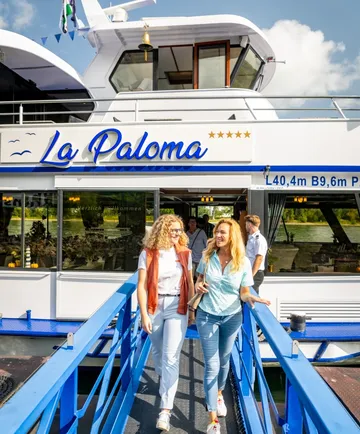 Two women walking on a boat ramp.