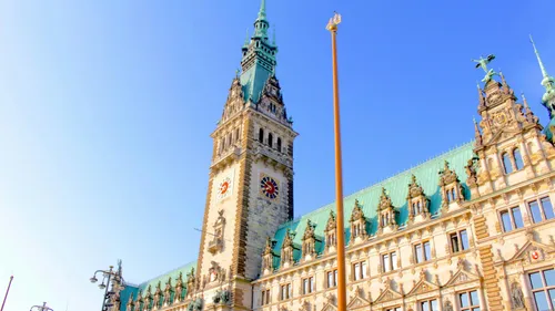Historic building with clock tower, sunny day.
