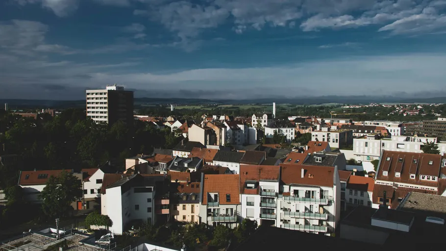 Cityscape view with buildings under cloudy sky.
