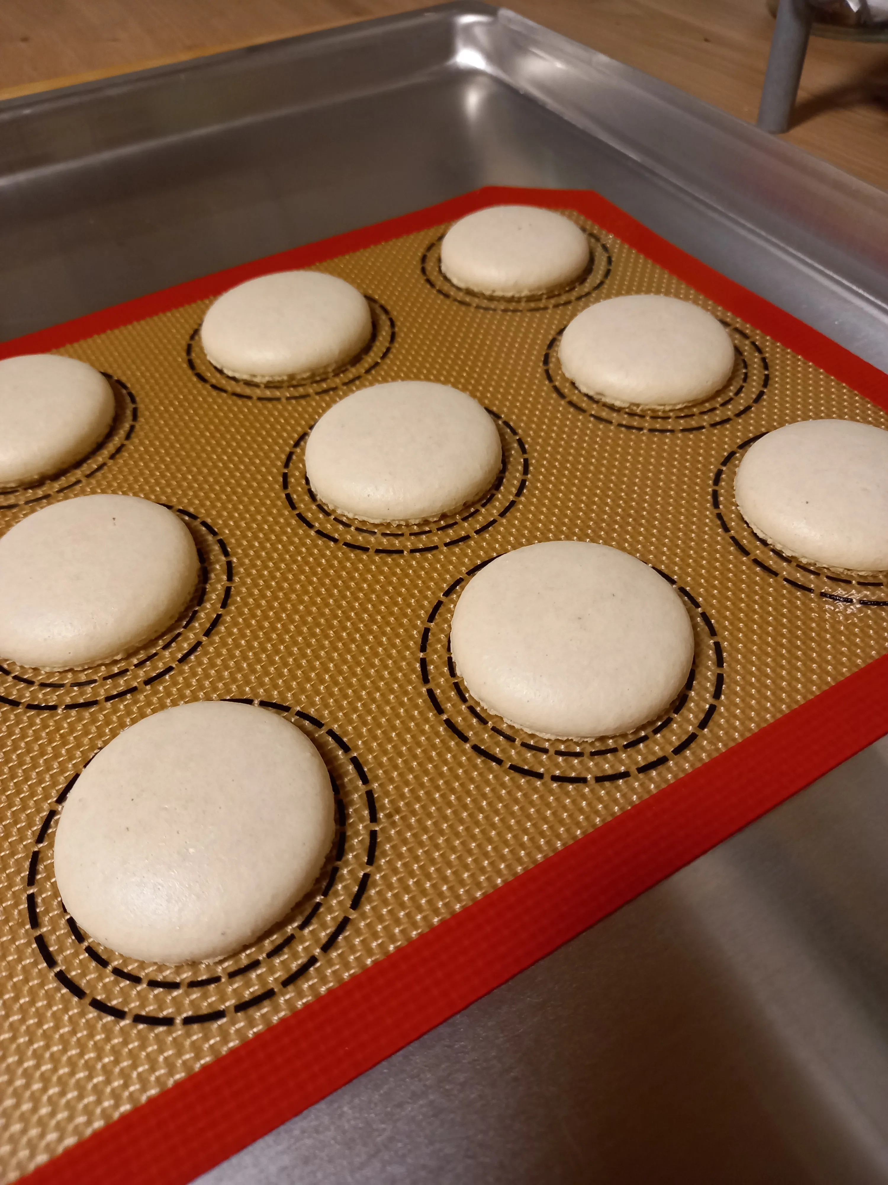 Macaron shells on silicon baking mat.
