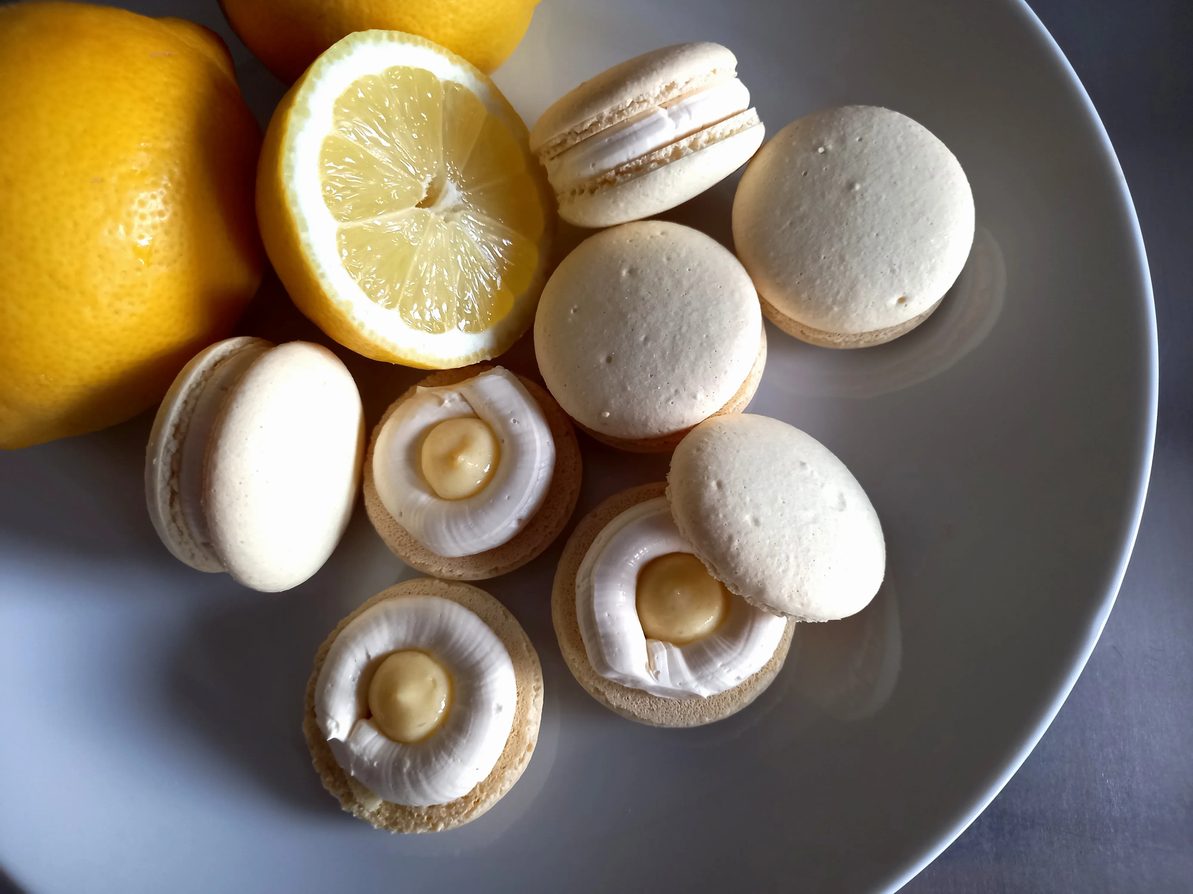Macarons with lemon filling on a plate.