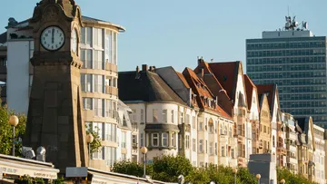 Clock tower and buildings in cityscape.