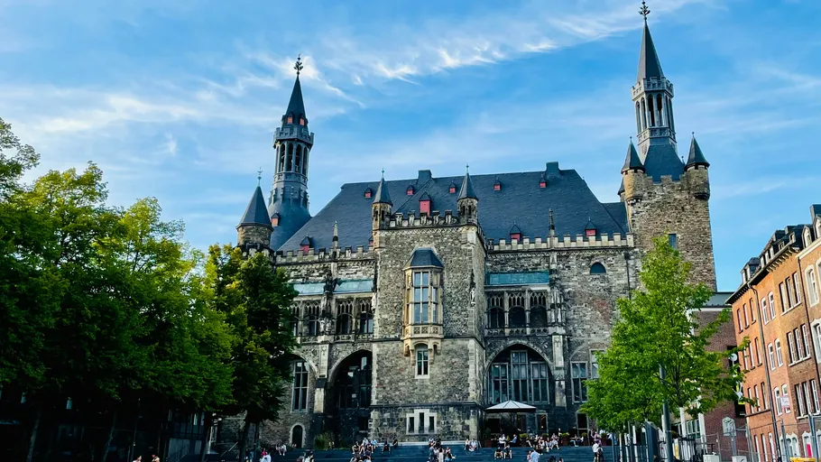 Historic building with towers, blue sky background.