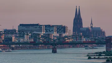 Brücke mit Zug, Kölner Dom im Hintergrund.