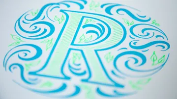 Stylized letter R with decorative swirls.