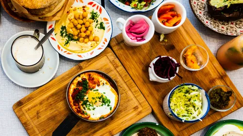 Variety of Mediterranean dishes on wooden boards.